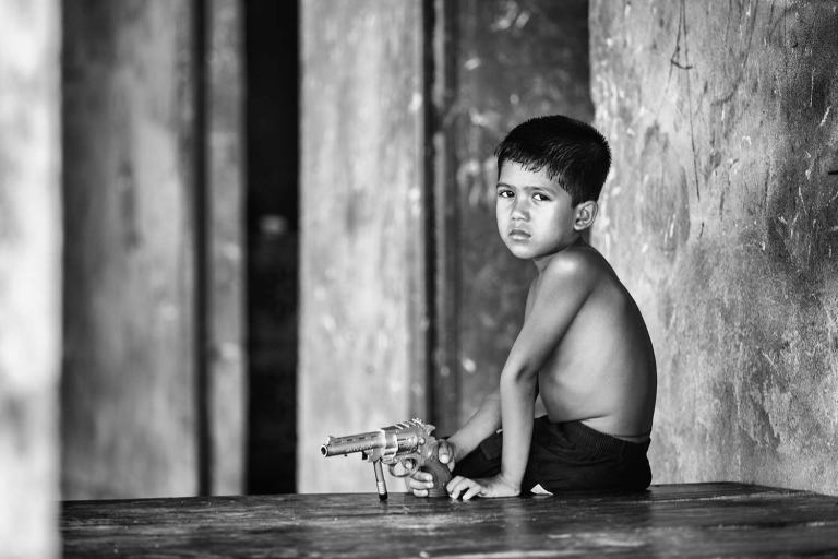 Bangladesh portrait boy with toy gun